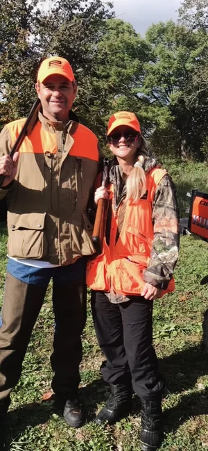 Tracey in blaze orange on a hunting trip.
